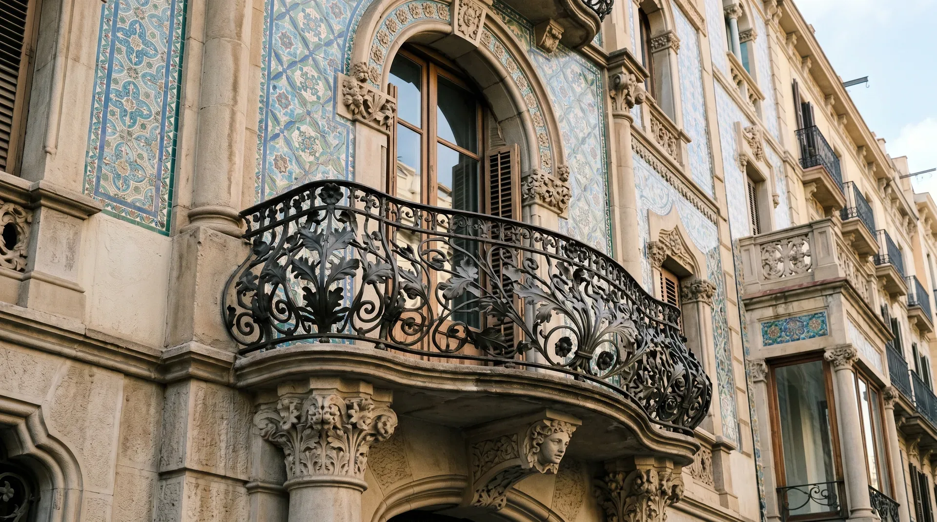 Close-up of Catalan Modernisme ceramic tile decoration and ironwork on a Barcelona facade